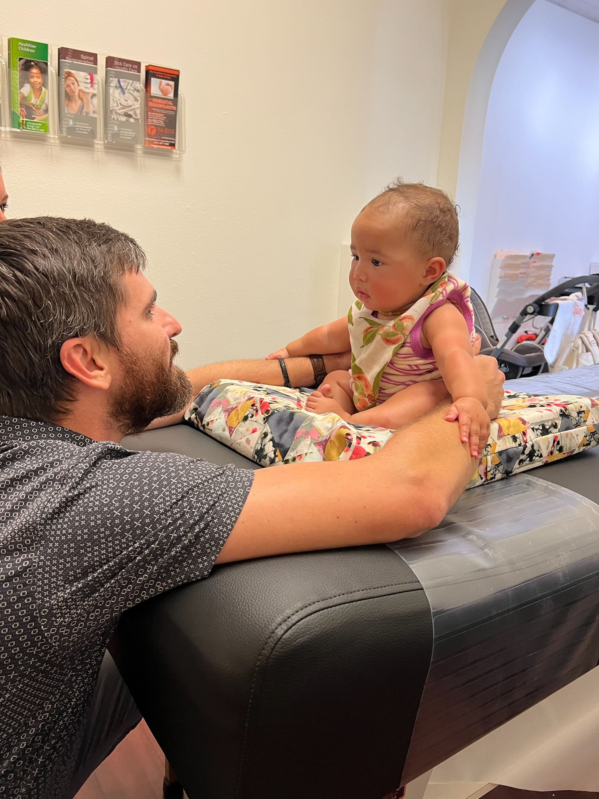 Dr. Logan Swaim working with a patient at Little Roots Pediatric Chiropractic