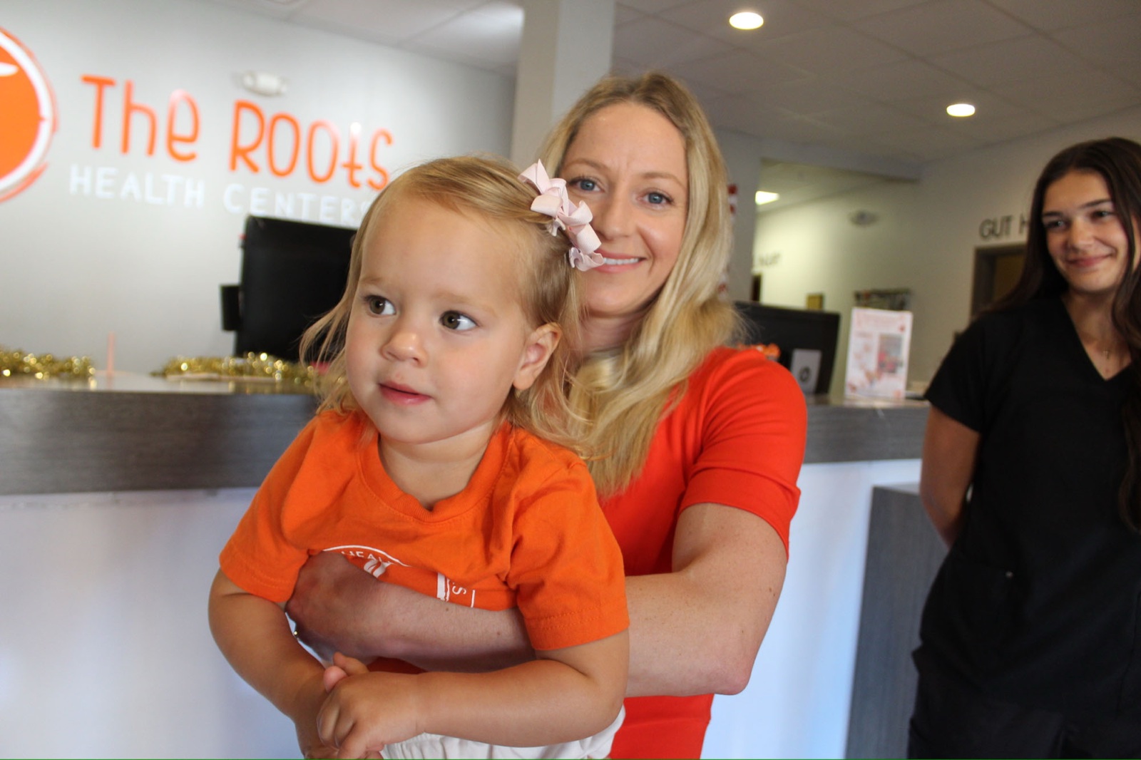 Dr. Laura Swaim with a toddler patient at reception.